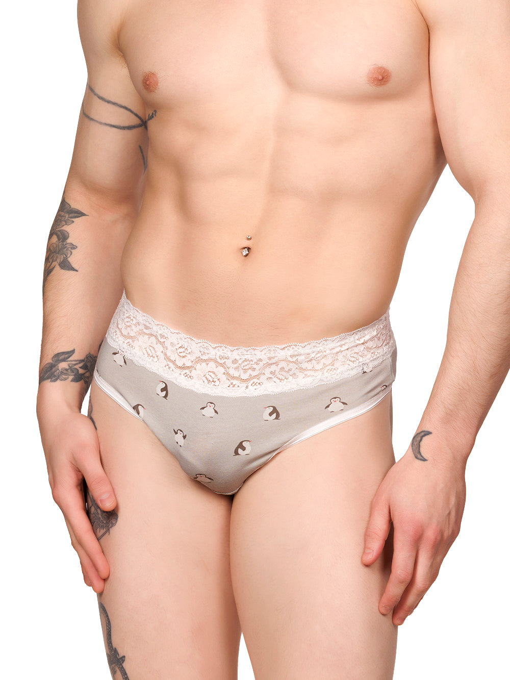 Front view of a male model wearing grey XDress thong panties with a white lace waistband and penguin print