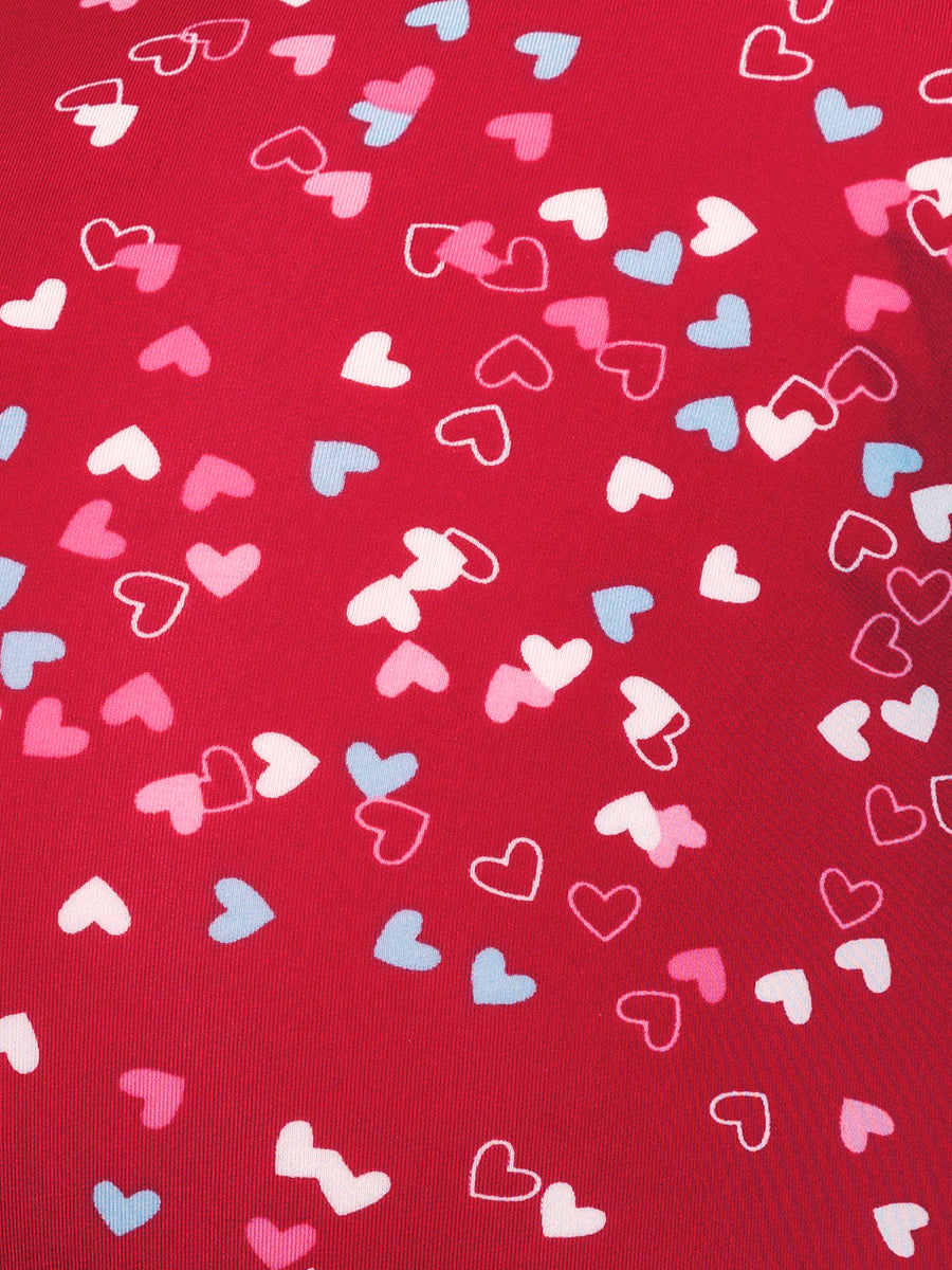 Closeup view of a red fabric with colored hearts pattern