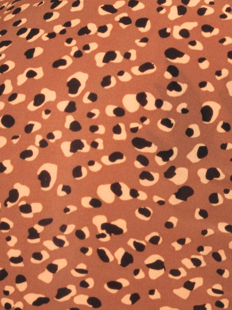 Closeup view of brown fabric with leopard print pattern