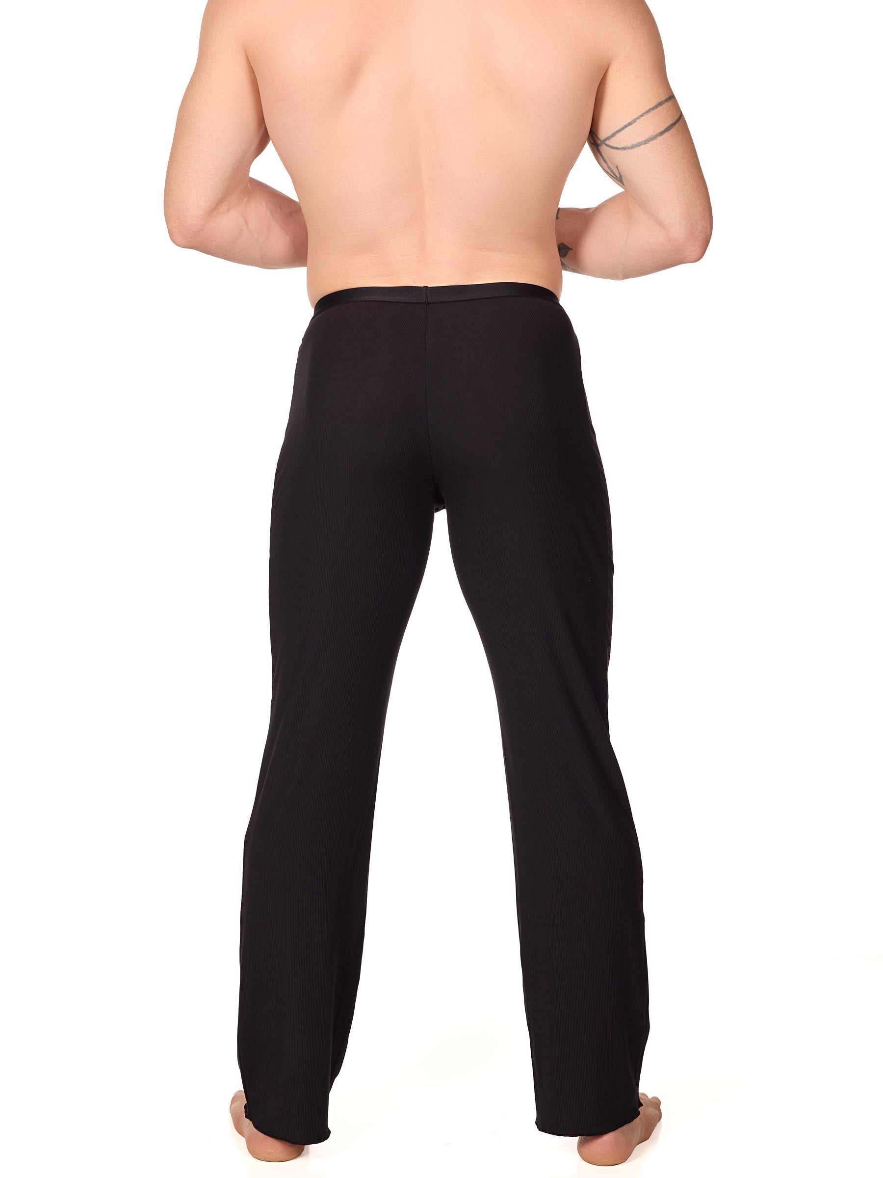 Back view of a man wearing black XDress lounge pants