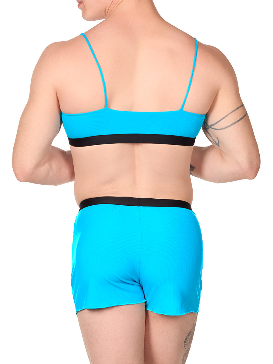 Back view of a man wearing a turquoise XDress bralette with matching shorts