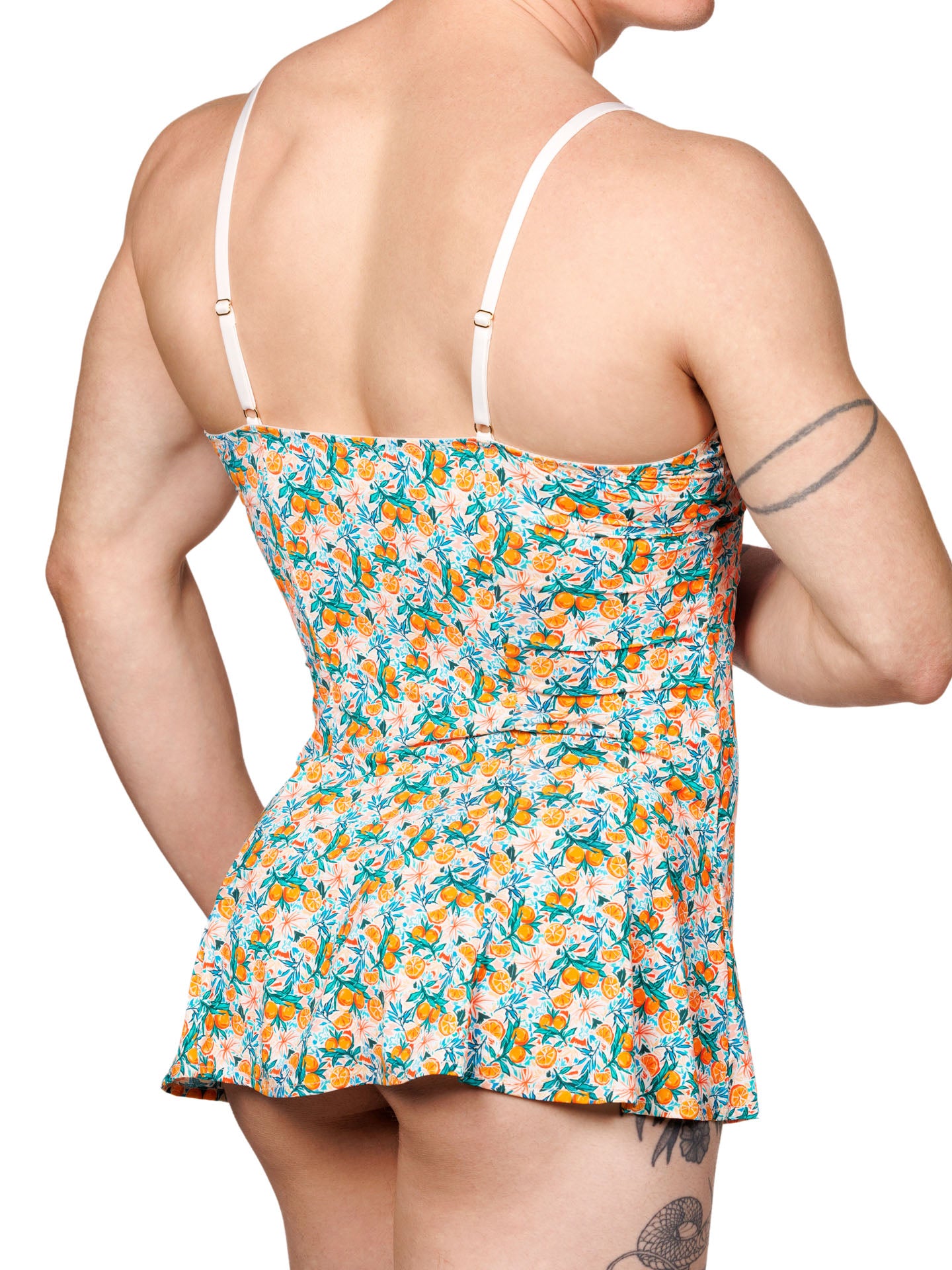 Back side view of a male model wearing an XDress babydoll with a vibrant orange blossom pattern.