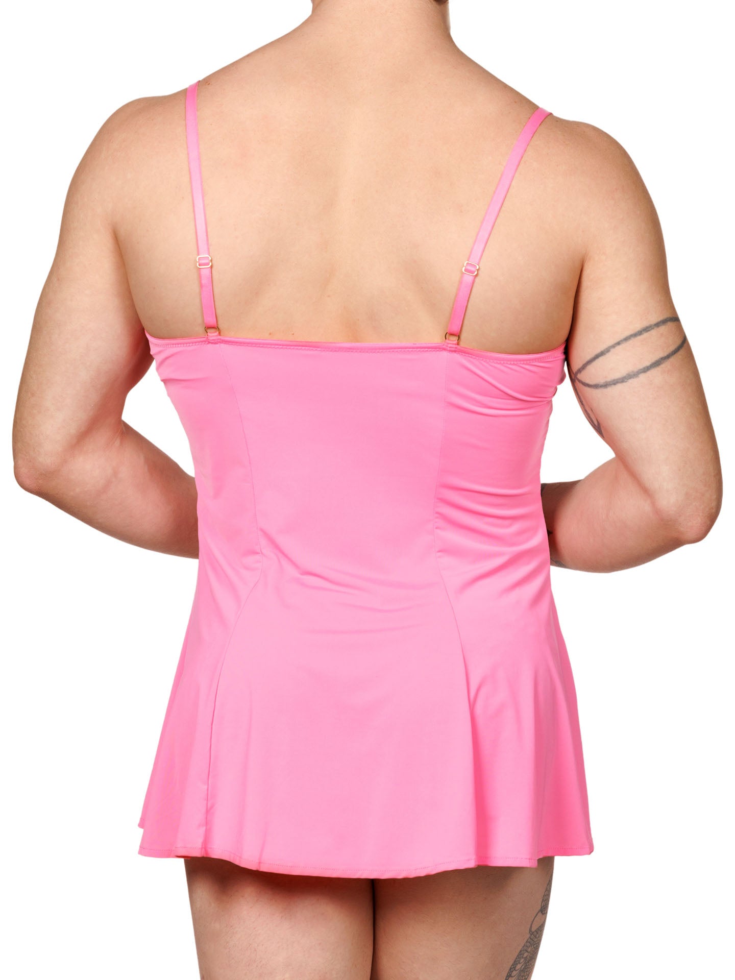 Back view of a male model wearing a pink men's babydoll with seamed underwire cups, adjustable shoulder straps and a flowing hem.