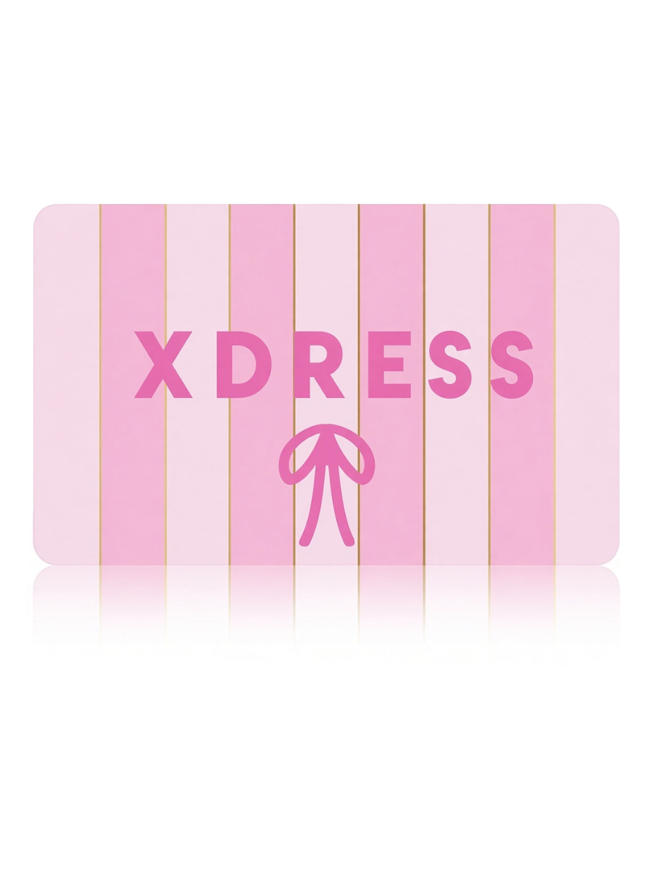 A pink rectangular card or tag with vertical pink stripes, the word 'XDRESS' in large pink letters, and a pink bow icon below, shown on a white background with a faint reflection.