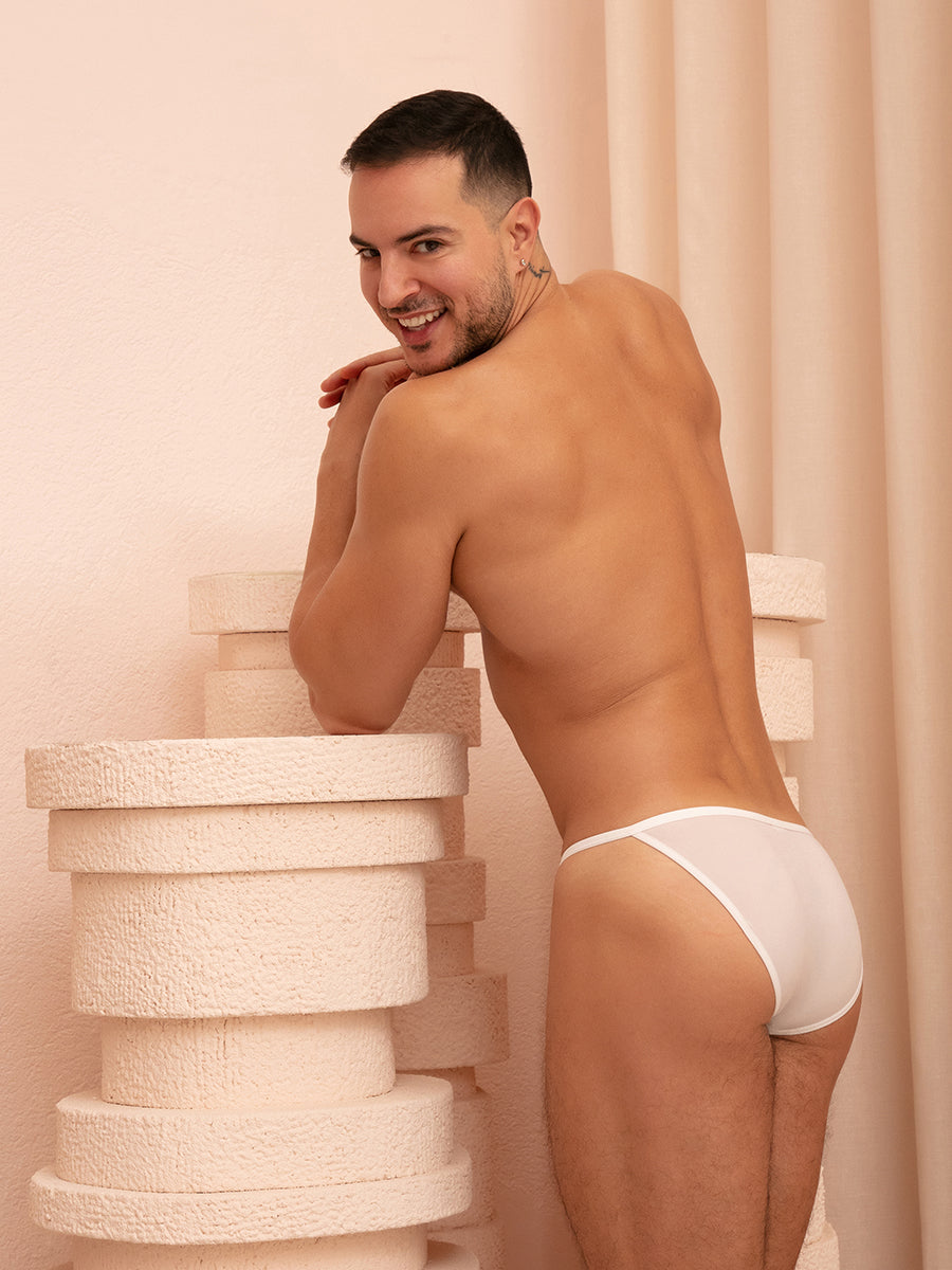 Rear view of a man wearing white XDress men's panties.