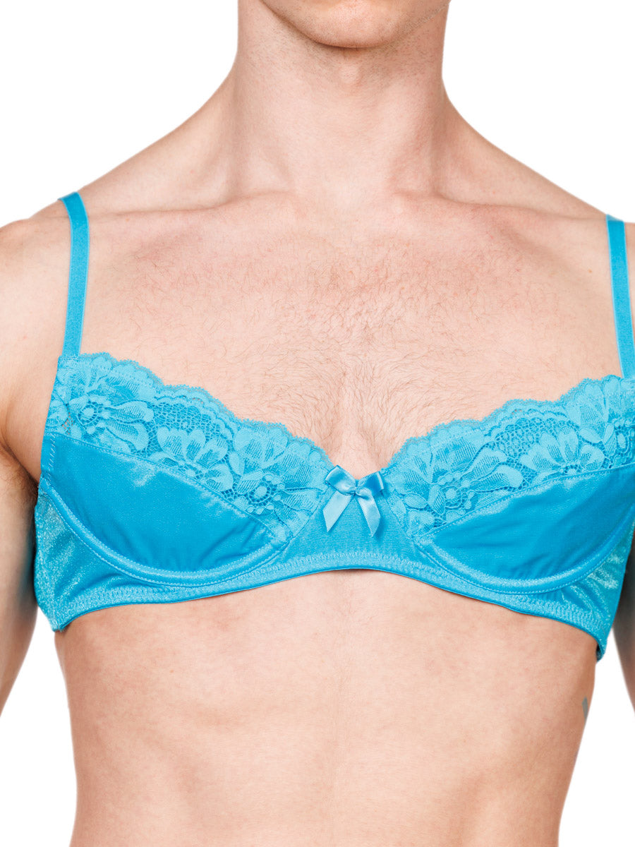 Closeup view of a male model wearing a turquoise XDress bra with lace trim