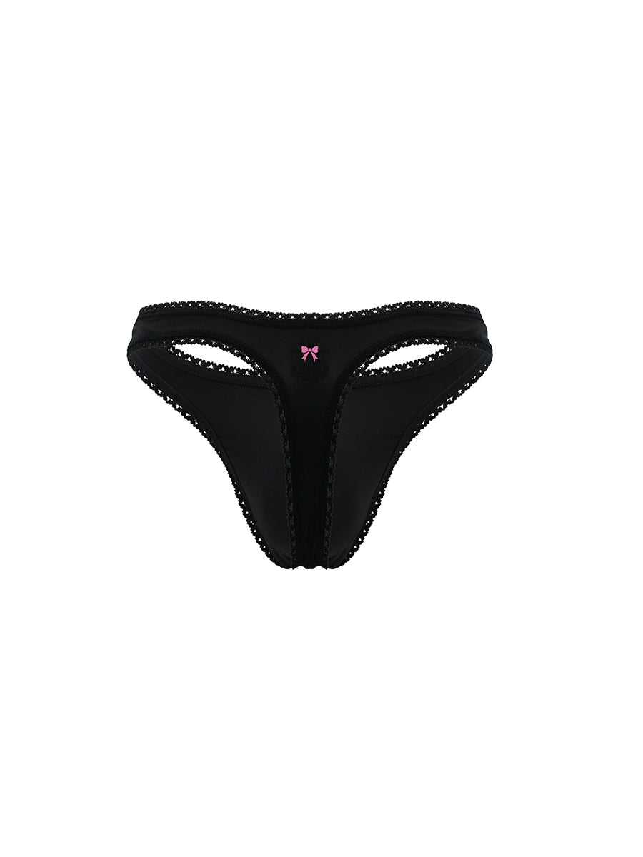 Black men's thong with a pink bow on a white background
