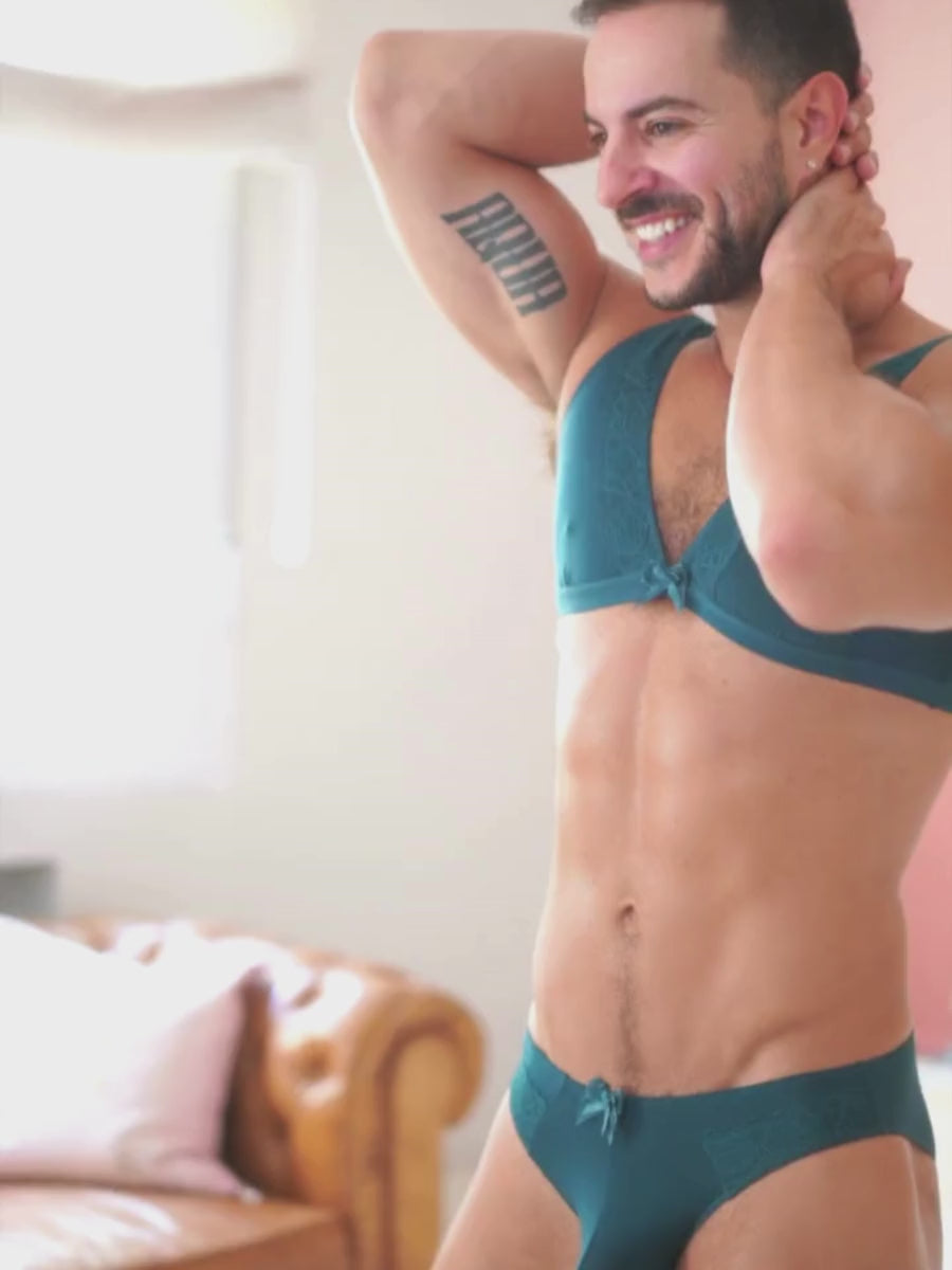 Video of a man posing in a matching teal bra and panty set from XDress.