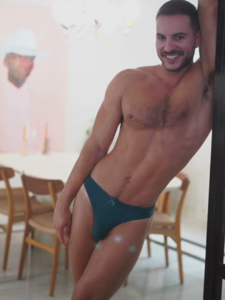 Video of a man posing in a teal thong panty from XDress